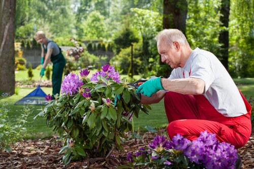 Supervisor reviewing site with gardeners during inspection